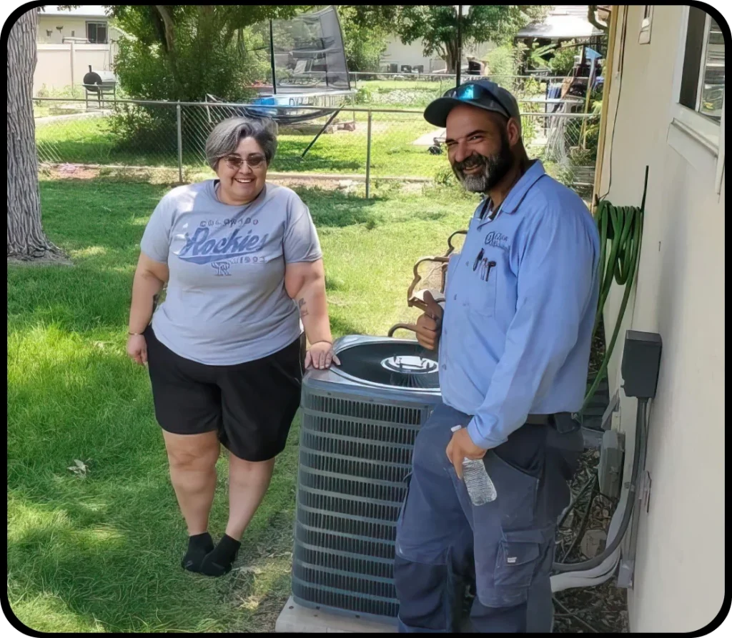 Picture of a Clarks Mechanical male technician posing for a picture with a female homeowner. Both are standing next to an HVAC unit.